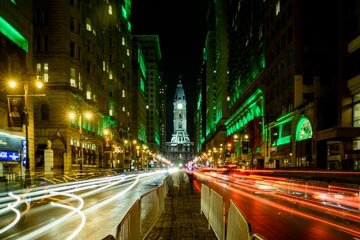 long exposure of broad street lit up green with trails of car lights