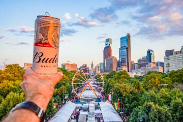 A budweiser beer in my hand 50 feet up in the air with the Philadelphia skyline in the background during made in america