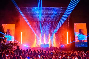 Concert with red flood light and high powered blue lasers